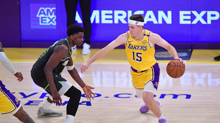 Apr 30, 2025; Los Angeles, California, USA; Los Angeles Lakers guard Austin Reaves (15) moves the ball against Minnesota Timberwolves guard Anthony Edwards (5) during the second half in game five of first round for the 2025 NBA Playoffs at Crypto.com Arena. Mandatory Credit: Gary A. Vasquez-Imagn Images