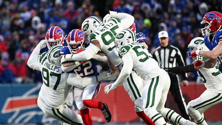 Jan 4, 2026; Orchard Park, New York, USA; New York Jets defensive tackle Harrison Phillips (97) and defensive end Eric Watts (95) tackle Buffalo Bills running back Ray Davis (22) during the first quarter at Highmark Stadium. Mandatory Credit: Mark Konezny-Imagn Images