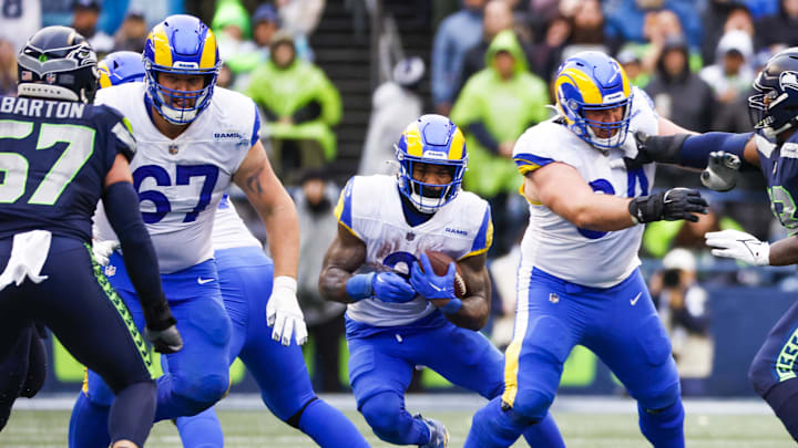 Jan 8, 2023; Seattle, Washington, USA; Los Angeles Rams running back Cam Akers (3) rushes against the Seattle Seahawks behind blocks from offensive tackle Chandler Brewer (67) and center Matt Skura (64) during the third quarter at Lumen Field. Mandatory Credit: Joe Nicholson-Imagn Images