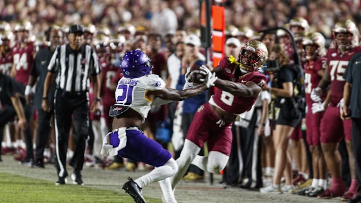 Nov 18, 2023; Tallahassee, Florida, USA; Florida State Seminoles tight end Jaheim Bell (6) catches the ball under pressure from North Alabama Lions linebacker Ashaad Williams (21) during the third quarter at Doak S. Campbell Stadium. Mandatory Credit: Morgan Tencza-Imagn Images Nov 18, 2023; Tallahassee, Florida, USA; Florida State Seminoles tight end Jaheim Bell (6) catches the ball under pressure from North Alabama Lions linebacker Ashaad Williams (21) during the third quarter at Doak S. Campbell Stadium. Mandatory Credit: Morgan Tencza-Imagn Images