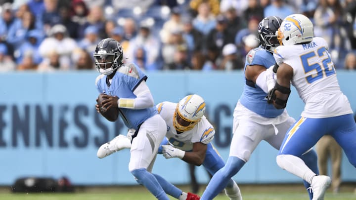 Nov 2, 2025; Nashville, Tennessee, USA; Los Angeles Chargers linebacker Daiyan Henley (0) sacks Tennessee Titans quarterback Cam Ward (1) during the second quarter at Nissan Stadium. Mandatory Credit: Steve Roberts-Imagn Images