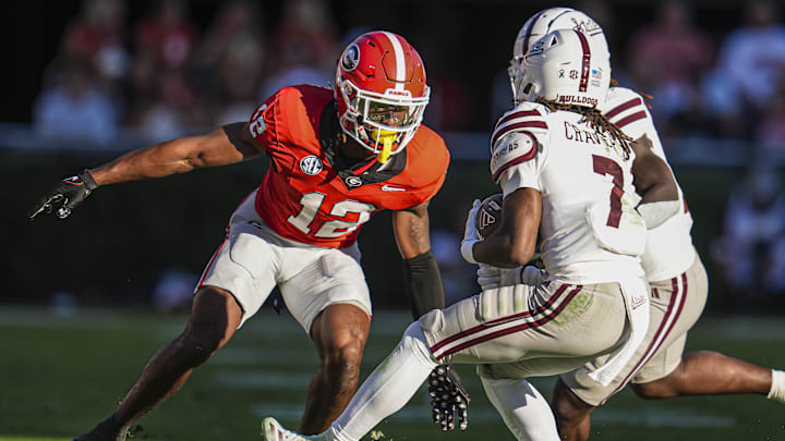 Oct 12, 2024; Athens, Georgia, USA; Georgia Bulldogs defensive back Julian Humphrey (12) tries got tackle Mississippi State Bulldogs wide receiver Mario Craver (7) at Sanford Stadium. Mandatory Credit: Dale Zanine-Imagn Images