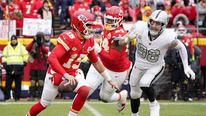 Dec 25, 2023; Kansas City, Missouri, USA; Kansas City Chiefs quarterback Patrick Mahomes (15) and Las Vegas Raiders defensive end Maxx Crosby (98) during the game at GEHA Field at Arrowhead Stadium. Mandatory Credit: Denny Medley-USA TODAY Sports