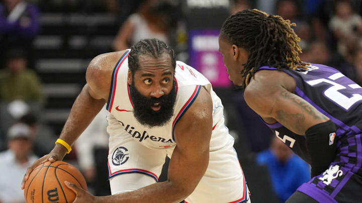 Apr 11, 2025; Sacramento, California, USA; Los Angeles Clippers guard James Harden (left) handles the ball against Sacramento Kings guard Keon Ellis (right) during the fourth quarter at Golden 1 Center. Mandatory Credit: Darren Yamashita-Imagn Images