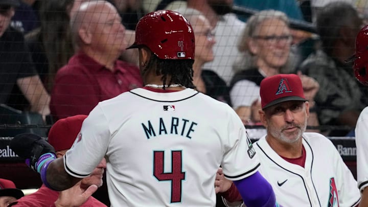 Diamondbacks' Ketel Marte (4) celebrates scoring with manager Torey Lovullo against the Rockies during a game at Chase Field. Diamondbacks' Ketel Marte (4) celebrates scoring with manager Torey Lovullo against the Rockies during a game at Chase Field.
