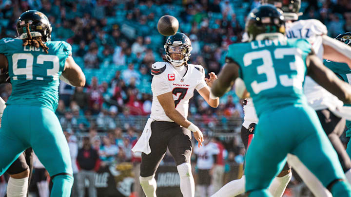 Dec 1, 2024; Jacksonville, Florida, USA; Houston Texans quarterback C.J. Stroud (7) throws the ball against Jacksonville Jaguars linebacker Devin Lloyd (33) in the third quarter at EverBank Stadium. Mandatory Credit: Jeremy Reper-Imagn Images