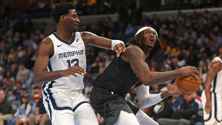 Nov 25, 2024; Memphis, Tennessee, USA; Portland Trail Blazers center Robert Williams III (35) handles the ball as Memphis Grizzlies forward Jaren Jackson Jr. (13) defends during the first half at FedExForum. Mandatory Credit: Petre Thomas-Imagn Images