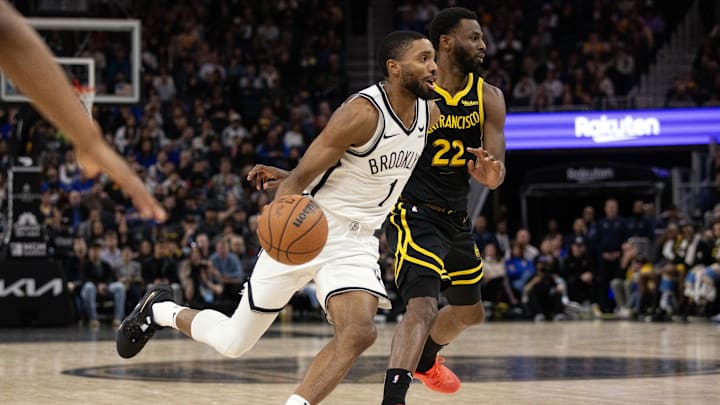 Dec 16, 2023; San Francisco, California, USA; Brooklyn Nets guard Mikal Bridges (1) drives past Golden State Warriors forward Andrew Wiggins (22) during the fourth quarter at Chase Center. Mandatory Credit: D. Ross Cameron-Imagn Images