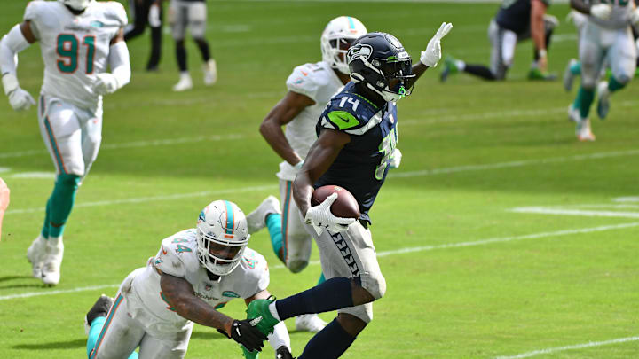 Oct 4, 2020; Miami Gardens, Florida, USA; Miami Dolphins outside linebacker Elandon Roberts (44) attempts to tackle Seattle Seahawks wide receiver DK Metcalf (14) during the second half at Hard Rock Stadium. Mandatory Credit: Jasen Vinlove-Imagn Images