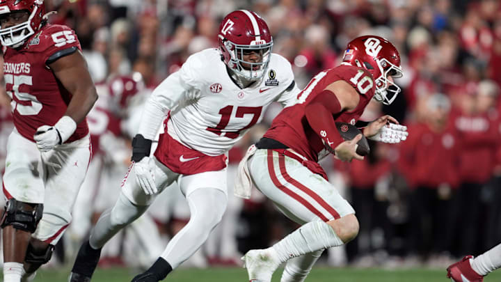 Alabama Crimson Tide linebacker Kelby Collins (17) brings down Oklahoma Sooners quarterback John Mateer (10) during a first-round College Football Playoff game between the University of Oklahoma Sooners (OU) and the Alabama Crimson Tide at Gaylord Family – Oklahoma Memorial Stadium in Norman, Okla., Friday, Dec. 19, 2025. Alabama won 34-24.