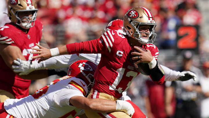 Oct 20, 2024; Santa Clara, California, USA; San Francisco 49ers quarterback Brock Purdy (13) is tackled by Kansas City Chiefs defensive end George Karlaftis (56) in the first quarter at Levi's Stadium. Mandatory Credit: Cary Edmondson-Imagn Images
