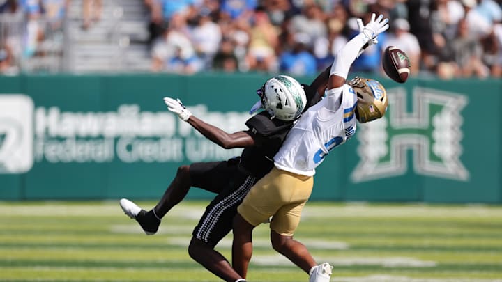 Aug 31, 2024; Honolulu, Hawaii, USA; Hawaii Rainbow Warriors wide receiver Alex Perry (0) can’t pull in a catch while being guarded by UCLA Bruins defensive back Kaylin Moore (9) during the third quarter of an NCAA college football game against the UCLA Bruins at the Clarence T.C. Ching Athletics Complex. Mandatory Credit: Marco Garcia-Imagn Images