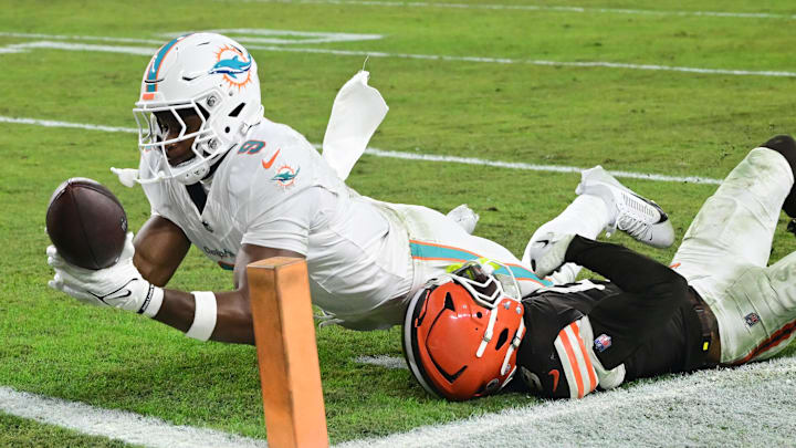Miami Dolphins tight end Jonnu Smith (9) scores a touchdown as Cleveland Browns safety Grant Delpit (9) defends during the second half at Huntington Bank Field.