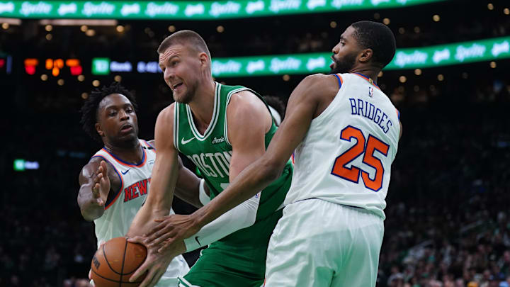 May 7, 2025; Boston, Massachusetts, USA; New York Knicks forward Mikal Bridges (25) and forward OG Anunoby (8) defend against Boston Celtics center Kristaps Porzingis (8) in the second half during game two of the second round for the 2025 NBA Playoffs at TD Garden. Mandatory Credit: David Butler II-Imagn Images