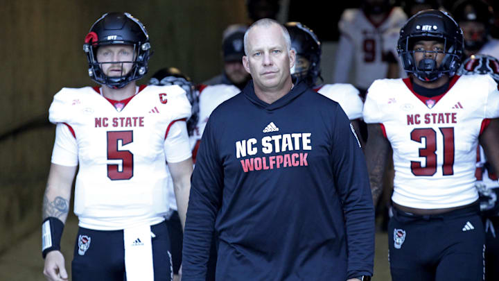 Nov 18, 2023; Blacksburg, Virginia, USA; North Carolina State Wolfpack head coach Dave Doeren walks to the field with his team before the game against the Virginia Tech Hokies at Lane Stadium. Mandatory Credit: Peter Casey-Imagn Images Nov 18, 2023; Blacksburg, Virginia, USA; North Carolina State Wolfpack head coach Dave Doeren walks to the field with his team before the game against the Virginia Tech Hokies at Lane Stadium. Mandatory Credit: Peter Casey-Imagn Images