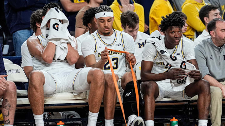 Michigan forward Yaxel Lendeborg (23), center, stretches from the bench during the second half against USC at Crisler Center in Ann Arbor on Friday, Jan. 2, 2026.