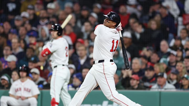 May 20, 2025; Boston, Massachusetts, USA; Boston Red Sox designated hitter Rafael Devers (11) hits a solo home run during the fifth inning against the New York Mets at Fenway Park. Mandatory Credit: Paul Rutherford-Imagn Images