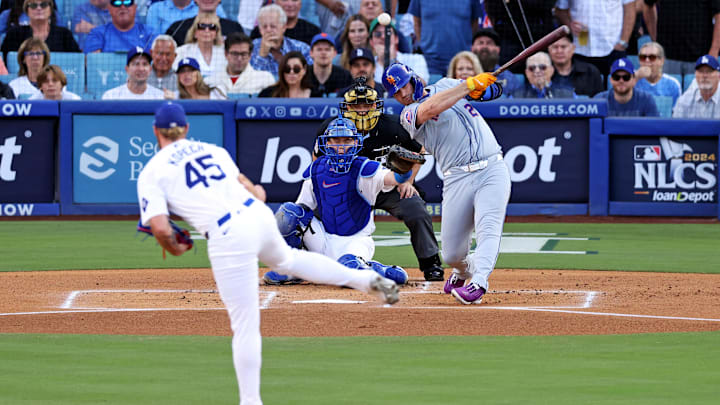Oct 20, 2024; Los Angeles, California, USA; New York Mets first base Pete Alonso (20) hits and reaches first base on an error during the first inning against the Los Angeles Dodgers during game six of the NLCS for the 2024 MLB playoffs at Dodger Stadium. Mandatory Credit: Jason Parkhurst-Imagn Images