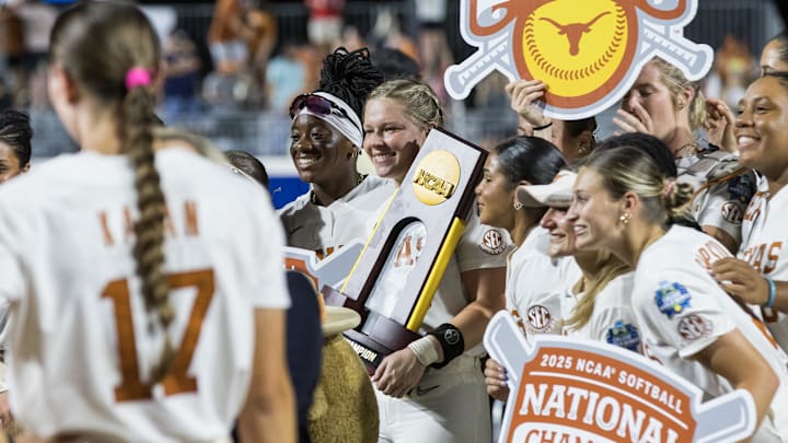Jun 6, 2025; Oklahoma City, OK, USA; Texas Longhorns infielder Joley Mitchell (9) smiles as she holds the National Championship trophy after the Longhorns defeated the Texas Tech Red Raiders 10-4 in game three of the NCAA Softball Women's College World Series finals at Devon Park. Jun 6, 2025; Oklahoma City, OK, USA; Texas Longhorns infielder Joley Mitchell (9) smiles as she holds the National Championship trophy after the Longhorns defeated the Texas Tech Red Raiders 10-4 in game three of the NCAA Softball Women's College World Series finals at Devon Park.