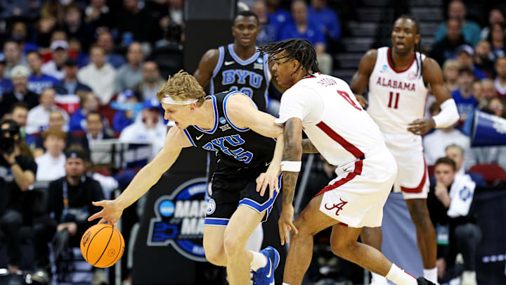 Mar 27, 2025; Newark, NJ, USA; Brigham Young Cougars forward Richie Saunders (15) steals the ball against Alabama Crimson Tide guard Labaron Philon (0) during the first half during an East Regional semifinal of the 2025 NCAA tournament at Prudential Center. Mandatory Credit: Vincent Carchietta-Imagn Images