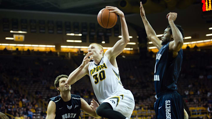 Dec 22, 2014; Iowa City, IA, USA; Iowa Hawkeyes forward Aaron White (30) drives against North Florida Ospreys guard/forward Beau Beech (2) at Carver-Hawkeye Arena. Iowa defeated North Florida 80-70. Mandatory Credit: Steven Branscombe-Imagn Images
