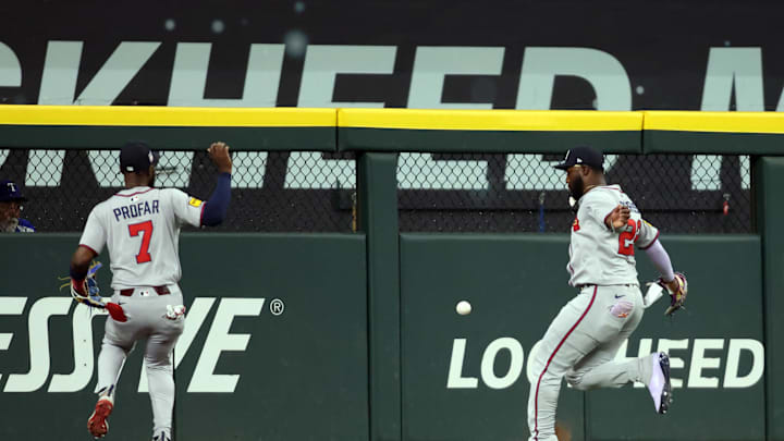 Jul 27, 2025; Arlington, Texas, USA; Atlanta Braves outfielder Jurickson Profar (7) and Atlanta Braves outfielder Michael Harris II (23) cannot catch a ball hit by Texas Rangers outfielder Wyatt Langford (not pictured) during the first inning at Globe Life Field. Mandatory Credit: Tim Heitman-Imagn Images