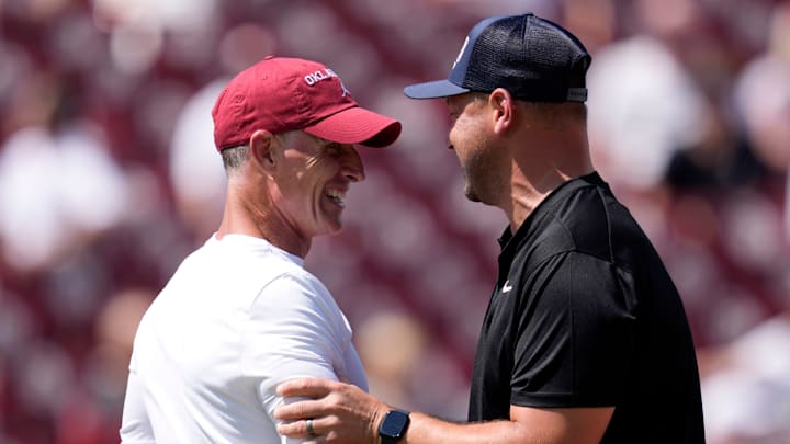 Oklahoma coach Brent Venables talks with Tulane coach Jon Sumrall before a college football game between the University of Oklahoma Sooners and the Tulane Green Wave 