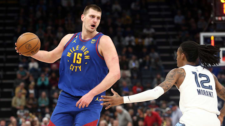 Denver Nuggets center Nikola Jokic (15) handles the ball as Memphis Grizzlies guard Ja Morant (12) defends during the first half at FedExForum. Mandatory Credit: Petre Thomas-Imagn Images