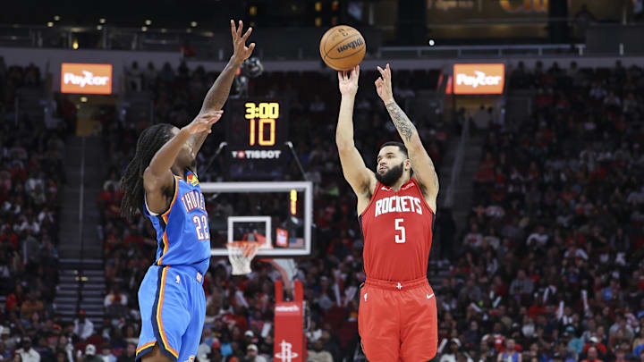 Dec 1, 2024; Houston, Texas, USA; Houston Rockets guard Fred VanVleet (5) shoots the ball as Oklahoma City Thunder guard Cason Wallace (22) defends during the fourth quarter at Toyota Center. Mandatory Credit: Troy Taormina-Imagn Images
