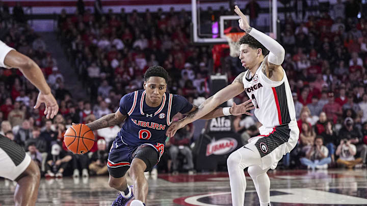 Jan 18, 2025; Athens, Georgia, USA; Auburn Tigers guard Tahaad Pettiford (0) dribbles against Georgia Bulldogs guard Dakota Leffew (1) at Stegeman Coliseum. Mandatory Credit: Dale Zanine-Imagn Images