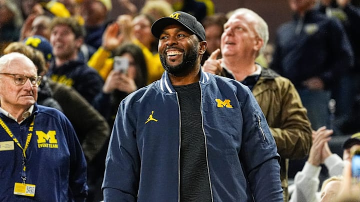 Michigan football head coach Sherron Moore smiles at fans during the first half against Iowa at Crisler Center in Ann Arbor on Saturday, Dec. 7, 2024.
