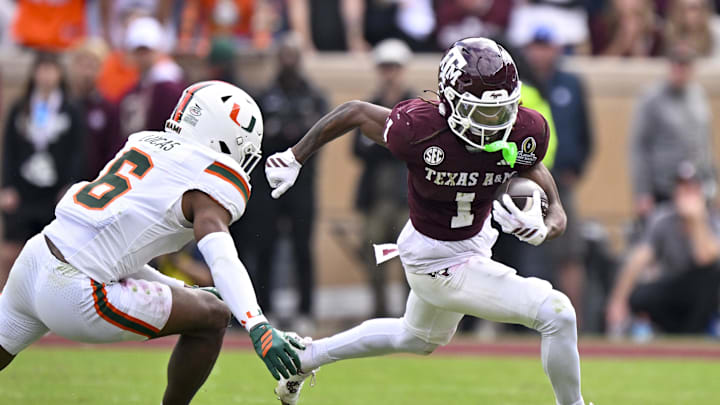 Dec 20, 2025; College Station, TX, USA; Texas A&M Aggies wide receiver Mario Craver (1) runs with the ball past Miami Hurricanes defensive back Xavier Lucas (6) during the game between the Aggies and the Hurricanes at Kyle Field. Mandatory Credit: Jerome Miron-Imagn Images