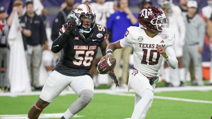 Dec 27, 2023; Houston, TX, USA; Texas A&M Aggies quarterback Marcel Reed (10) scrambles from Oklahoma State Cowboys defensive end Xavier Ross (56) in the second half at NRG Stadium. Mandatory Credit: Thomas Shea-Imagn Images Dec 27, 2023; Houston, TX, USA; Texas A&M Aggies quarterback Marcel Reed (10) scrambles from Oklahoma State Cowboys defensive end Xavier Ross (56) in the second half at NRG Stadium. Mandatory Credit: Thomas Shea-Imagn Images