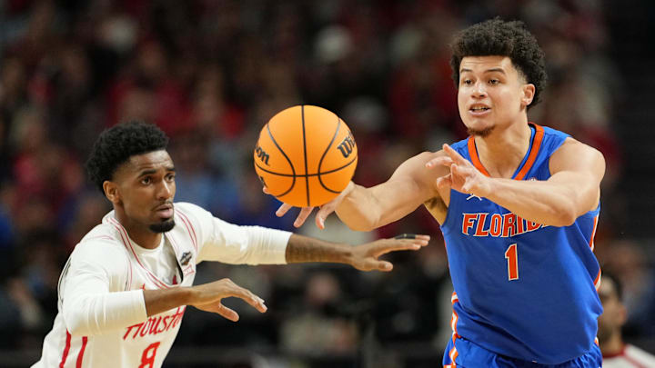 Apr 7, 2025; San Antonio, TX, USA; Florida Gators guard Walter Clayton Jr. (1) passes the ball against Houston Cougars guard Mylik Wilson (8) during the first half of the national championship game of the Final Four of the 2025 NCAA Tournament at the Alamodome. Mandatory Credit: Bob Donnan-Imagn Images