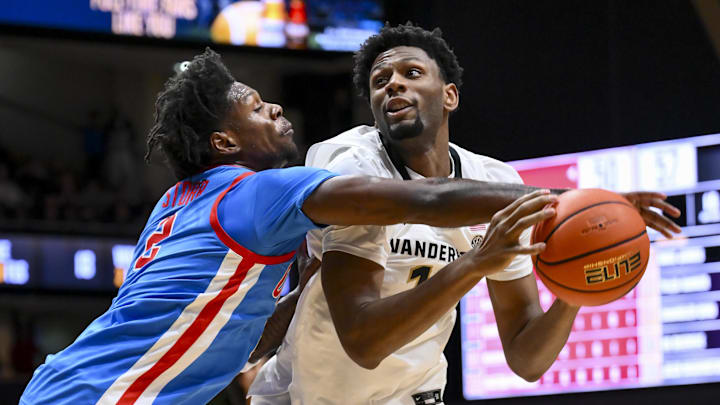 Jan 31, 2026; Nashville, TN, USA;  Vanderbilt Commodores forward Jalen Washington (13) gets fouled by Mississippi Rebels guard AJ Storr (2) during the second half at Memorial Gymnasium. Mandatory Credit: Steve Roberts-Imagn Images