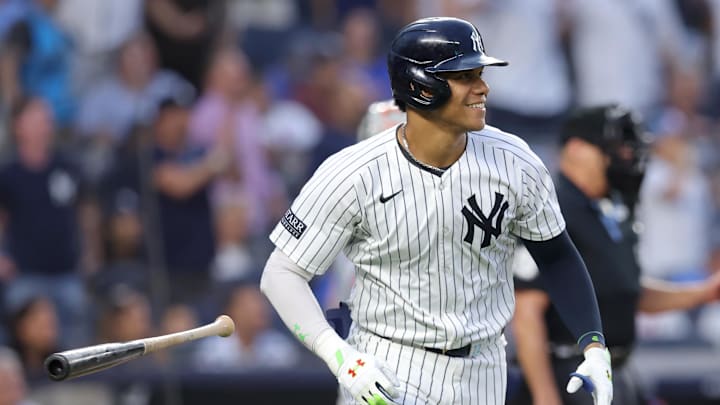 Jul 24, 2024; Bronx, New York, USA; New York Yankees right fielder Juan Soto (22) flips his bat after hitting a solo home run against the New York Mets during the third inning at Yankee Stadium. Mandatory Credit: Brad Penner-Imagn Images