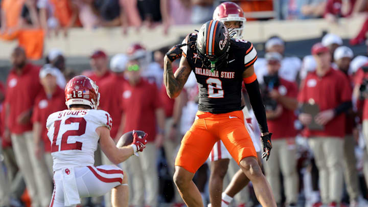 Oklahoma State's Korie Black (2) celebrates a defensive stop next to Oklahoma's Drake Stoops (12) during a Bedlam college football game between the Oklahoma State University Cowboys (OSU) and the University of Oklahoma Sooners (OU) at Boone Pickens Stadium in Stillwater, Okla., Saturday, Nov. 4, 2023.