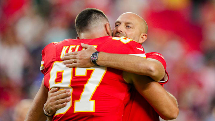 Oct 12, 2025; Kansas City, Missouri, USA; Kansas City Chiefs offensive coordinator Matt Nagy hugs tight end Travis Kelce (87) prior to a game against the Detroit Lions at GEHA Field at Arrowhead Stadium. Mandatory Credit: Jay Biggerstaff-Imagn Images