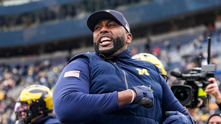 Michigan head coach Sherrone Moore cheers as he runs onto the field for warmups at Michigan Stadium in Ann Arbor on Saturday, Nov. 29, 2025. Michigan head coach Sherrone Moore cheers as he runs onto the field for warmups at Michigan Stadium in Ann Arbor on Saturday, Nov. 29, 2025.