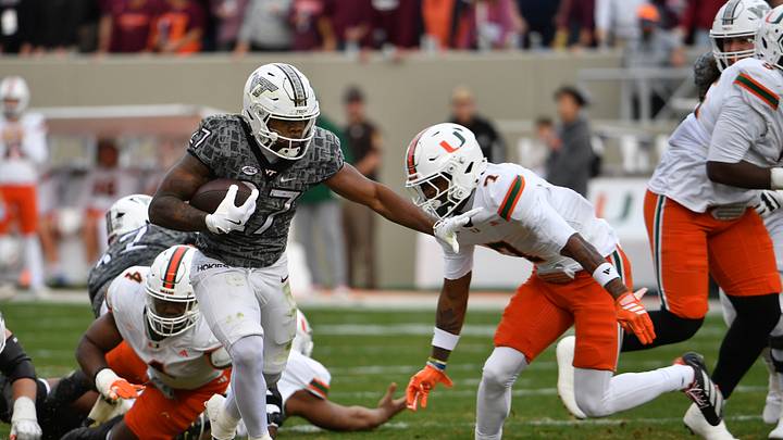 Nov 22, 2025; Blacksburg, Virginia, USA; Miami (FL) Hurricanes safety Zechariah Poyser (7) attempts to tackle Virginia Tech Hokies running back Marcellous Hawkins (27) during the first quarter at Lane Stadium. Mandatory Credit: Brian Bishop-Imagn Images Nov 22, 2025; Blacksburg, Virginia, USA; Miami (FL) Hurricanes safety Zechariah Poyser (7) attempts to tackle Virginia Tech Hokies running back Marcellous Hawkins (27) during the first quarter at Lane Stadium. Mandatory Credit: Brian Bishop-Imagn Images