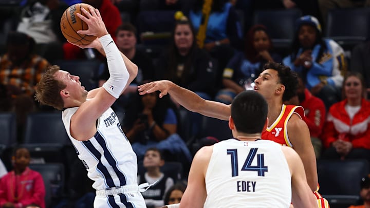 Mar 3, 2025; Memphis, Tennessee, USA; Memphis Grizzlies guard Luke Kennard (10) shoots as Atlanta Hawks forward Zaccharie Risacher (10) defends during the first quarter at FedExForum. Mandatory Credit: Petre Thomas-Imagn Images