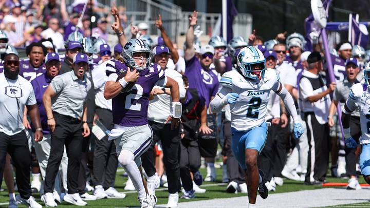 Sep 19, 2026; Manhattan, Kansas, USA;  Kansas State Wildcats quarterback Avery Johnson (2) run away from Tulane Green Wave linebacker Dickson Agu (2) for a 66-yard gain in the second quarter at Bill Snyder Family Football Stadium.  Mandatory Credit: Scott Sewell-Imagn Images