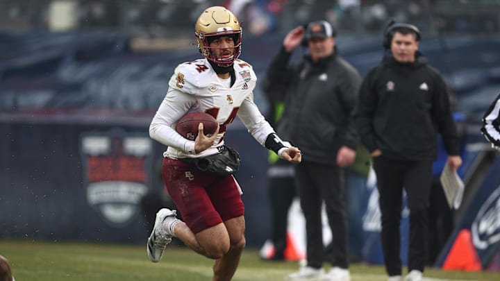 Dec 28, 2024; Bronx, NY, USA; Boston College Eagles quarterback Grayson James (14) carries the ball during the first half against the Nebraska Cornhuskers at Yankee Stadium. Mandatory Credit: Vincent Carchietta-Imagn Images