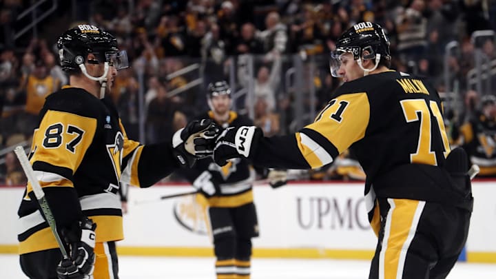 Nov 19, 2023; Pittsburgh, Pennsylvania, USA;  Pittsburgh Penguins center Sidney Crosby (87) congratulates center Evgeni Malkin (71) on his empty net goal against the Vegas Golden Knights during the third period at PPG Paints Arena. Pittsburgh won 3-0. Mandatory Credit: Charles LeClaire-Imagn Images
