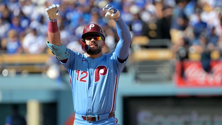 Oct 9, 2025; Los Angeles, California, USA; Philadelphia Phillies left fielder Kyle Schwarber (12) reacts after a double in the first inning against the Los Angeles Dodgers during game four of the NLDS round for the 2025 MLB playoffs at Dodger Stadium. Mandatory Credit: Jayne Kamin-Oncea-Imagn Images