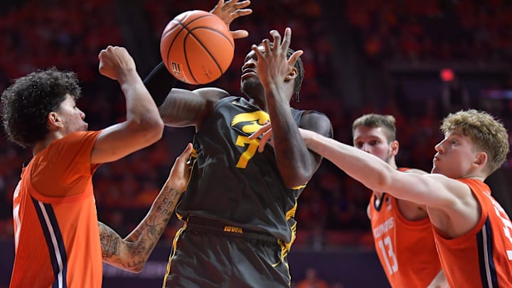 Feb 25, 2025; Champaign, Illinois, USA;  Illinois Fighting Illini forward Will Riley (7) and Kasparas Jakucionis (32) knock the ball from Iowa Hawkeyes forward Seydou Traore (7) during the second half at State Farm Center. Mandatory Credit: Ron Johnson-Imagn Images