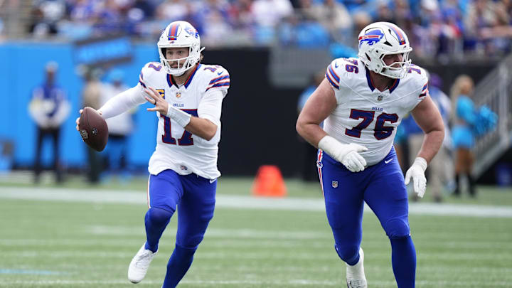 Oct 26, 2025; Charlotte, North Carolina, USA; Buffalo Bills quarterback Josh Allen (17) scrambles behind guard David Edwards (76) during the first half against the Carolina Panthers at Bank of America Stadium. Mandatory Credit: Jim Dedmon-Imagn Images