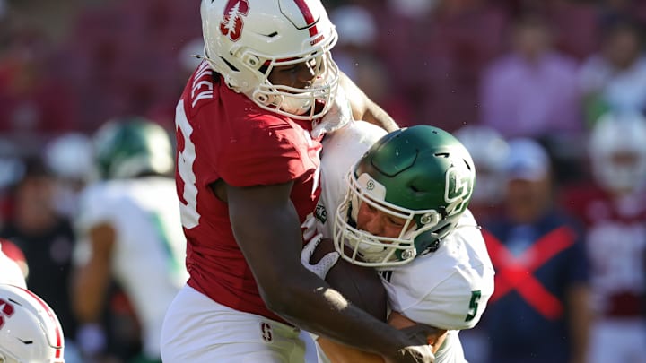 Sep 7, 2024; Stanford, California, USA; Cal Poly Mustangs running back Aiden Ramos (5) is tackled by Stanford Cardinal linebacker David Bailey (23) during the second half at Stanford Stadium. Mandatory Credit: Sergio Estrada-Imagn Images