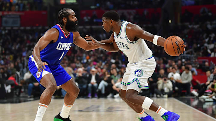 Mar 12, 2024; Los Angeles, California, USA; Minnesota Timberwolves guard Anthony Edwards (5) controls the ball against Los Angeles Clippers guard James Harden (1) during the first half at Crypto.com Arena. Mandatory Credit: Gary A. Vasquez-Imagn Images