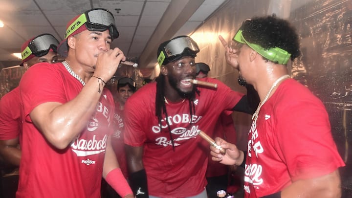 Sep 28, 2025; Milwaukee, Wisconsin, USA;  Cincinnati Reds shortstop Elly De La Cruz (center) celebrates after the Reds clinched a wild card spot after the game against the Milwaukee Brewers at American Family Field. Mandatory Credit: Benny Sieu-Imagn Images